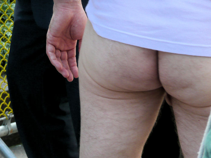 photograph of man's bare bum at st stupids day parade in san francisco